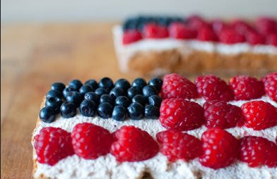 A dessert decorated with blueberries and raspberries in a flag pattern.